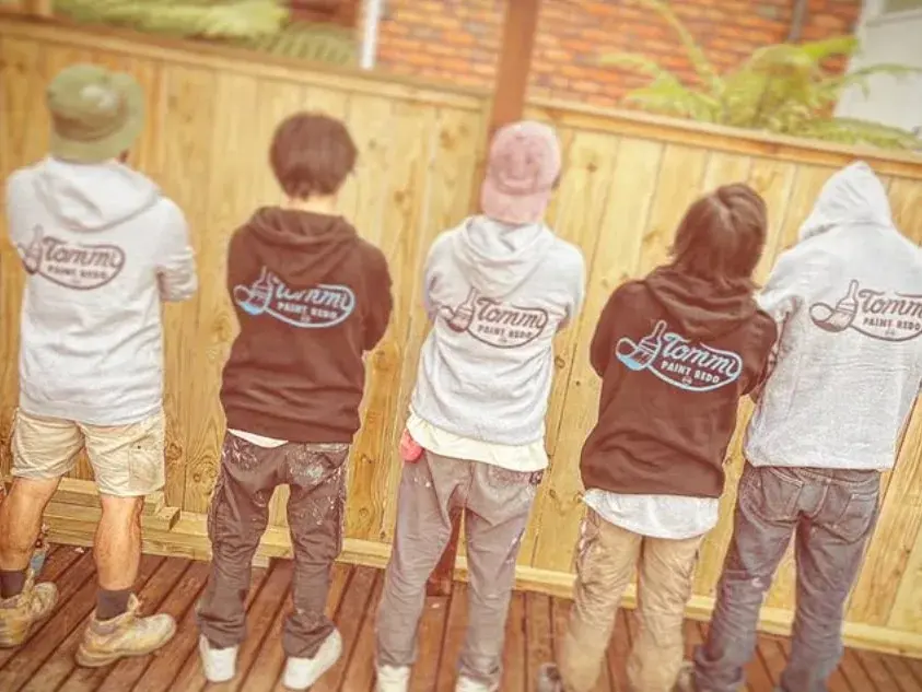 Tommy Paint Redo crew on site in branded hoodies after a painting job in Auckland